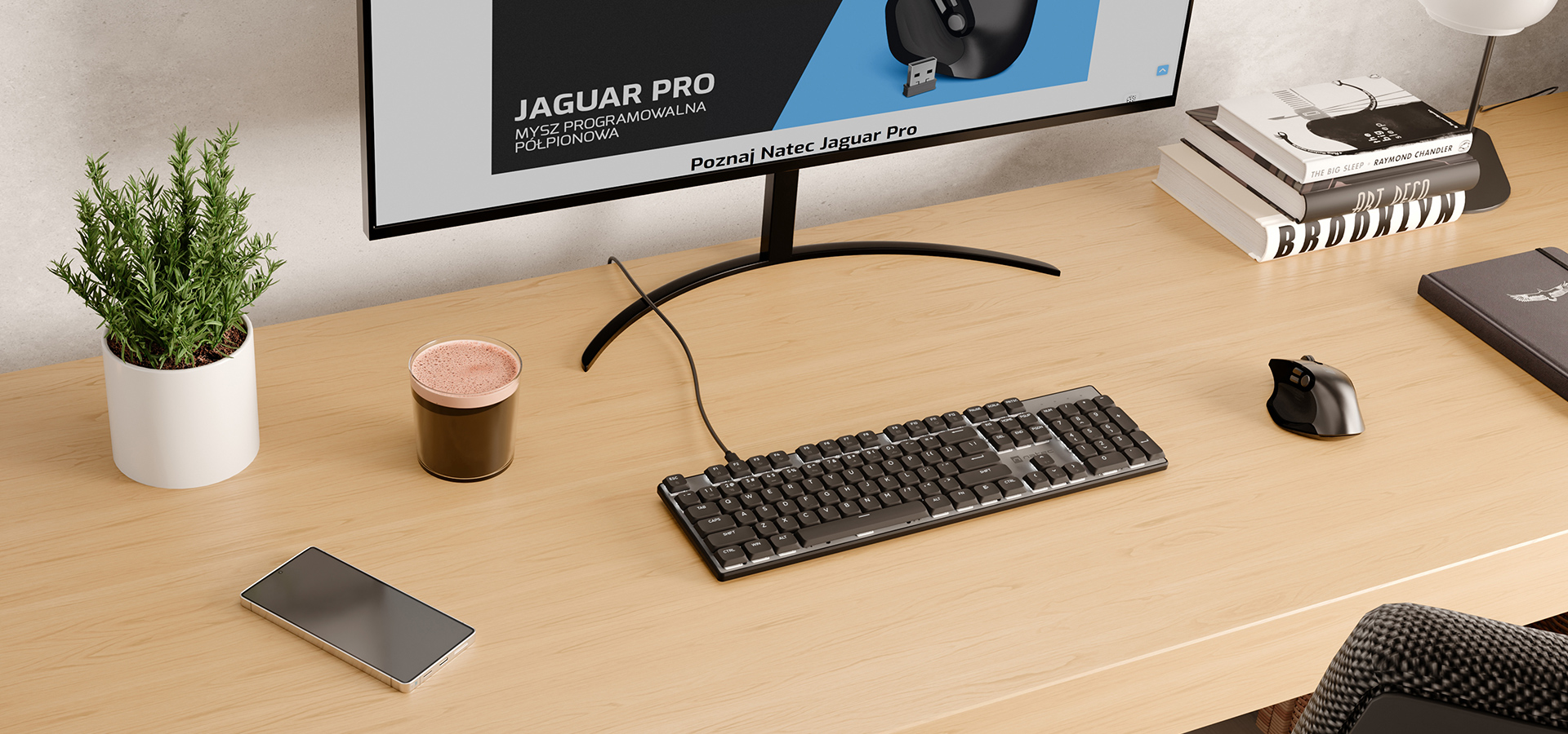 A modern workspace with a keyboard, mouse, phone, plant, cup, and monitor on a wooden desk.