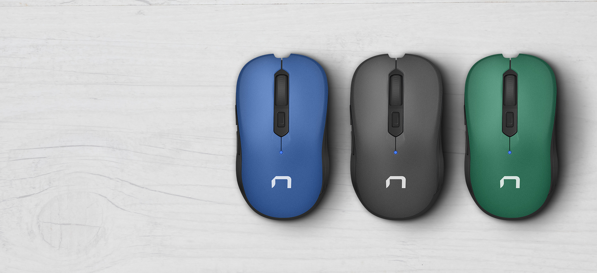 Three computer mice in blue, black, and green colors arranged in a row on a light background.