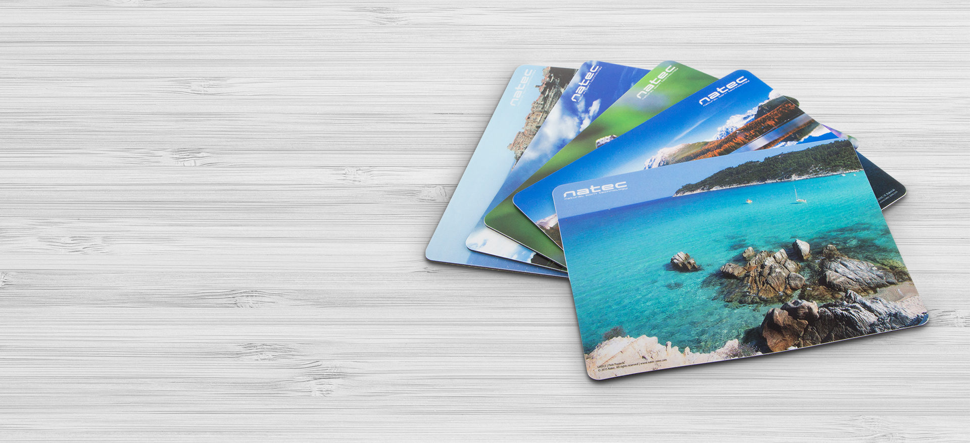 Collection of colorful mouse pads featuring beach and ocean designs on a light background.