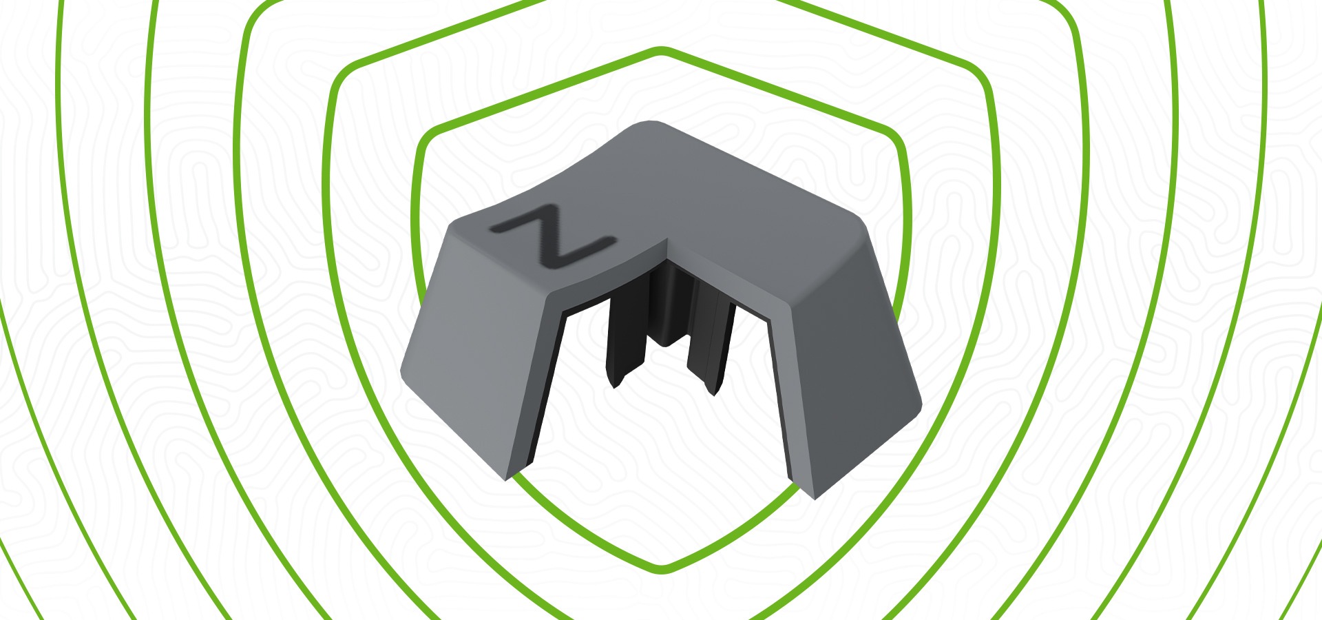 Szara nakładka na klawisz z stylizowaną literą i wielobocznym wzorem.