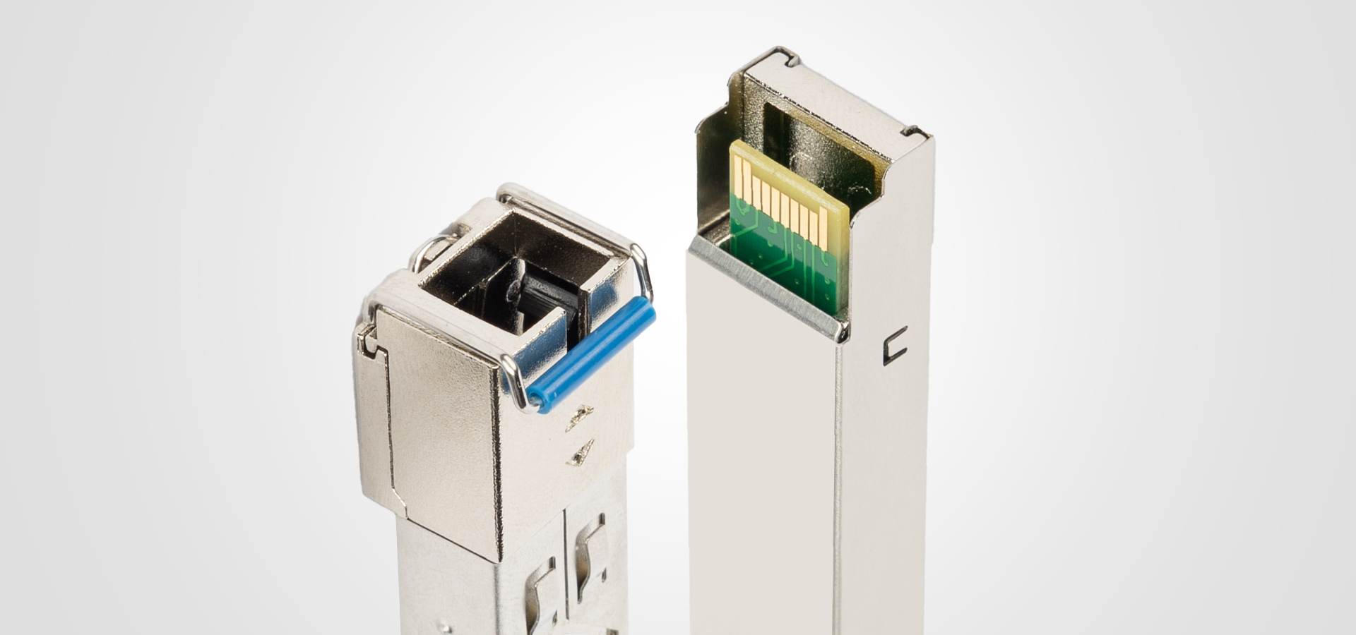 Two metal connectors with one featuring a blue latch and differing internal contacts.