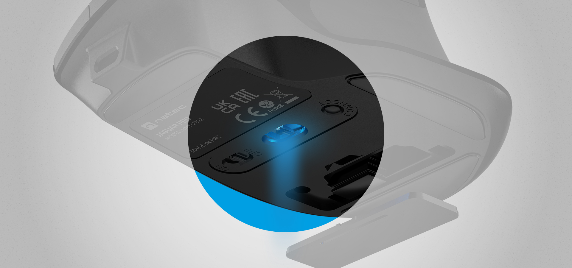 Mouse bottom view with a glowing light and connection ports displayed clearly.