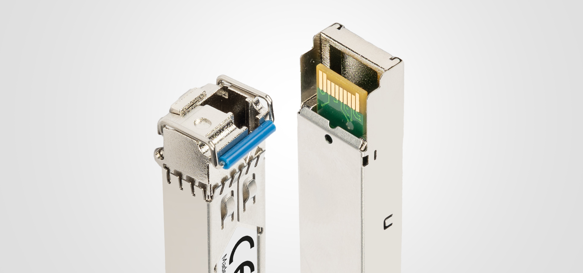 Two metallic connectors, one partially opened, showing internal circuits and a blue component.