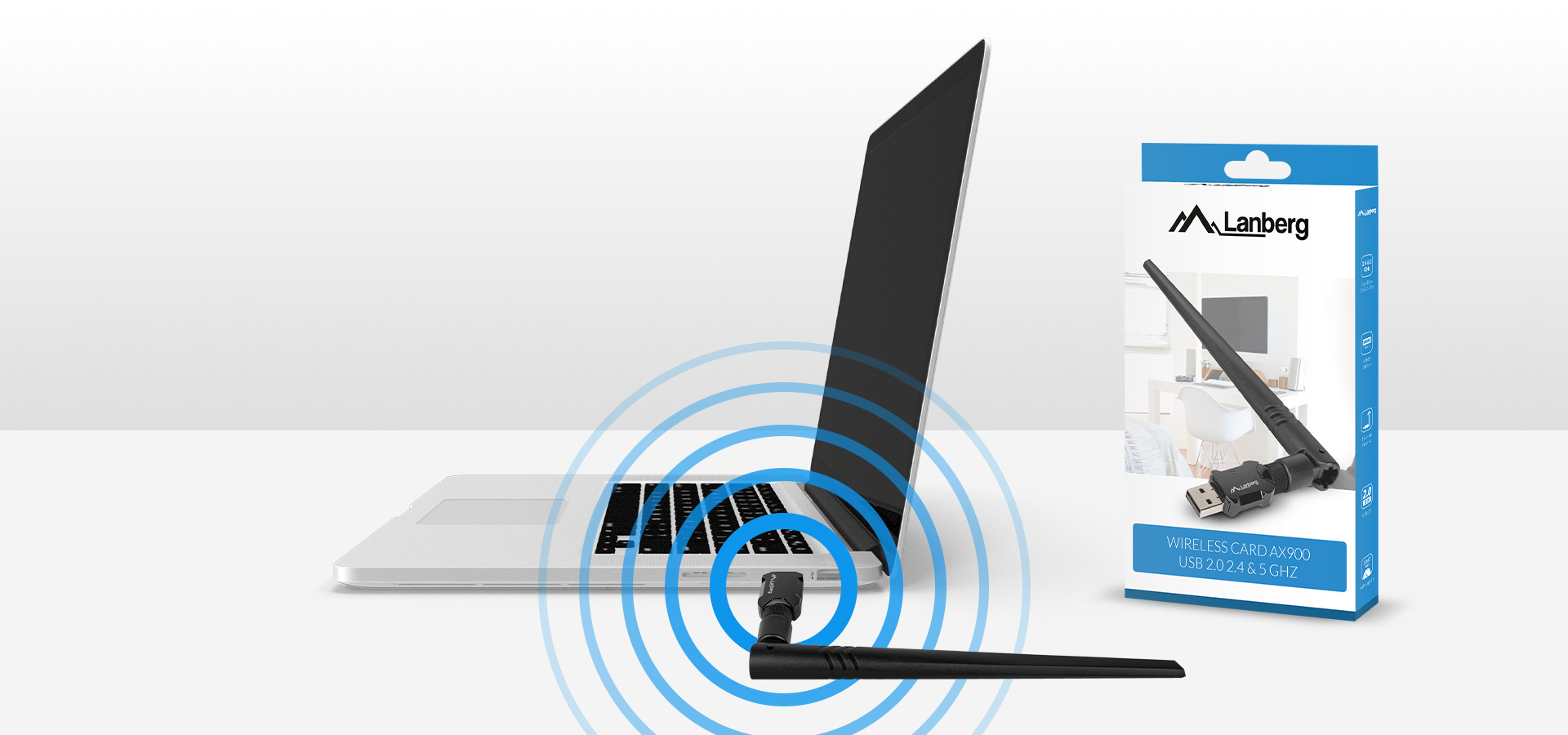 Bezprzewodowa karta sieciowa z dwiema antenami i opakowanie obok laptopa z falami połączeniowymi