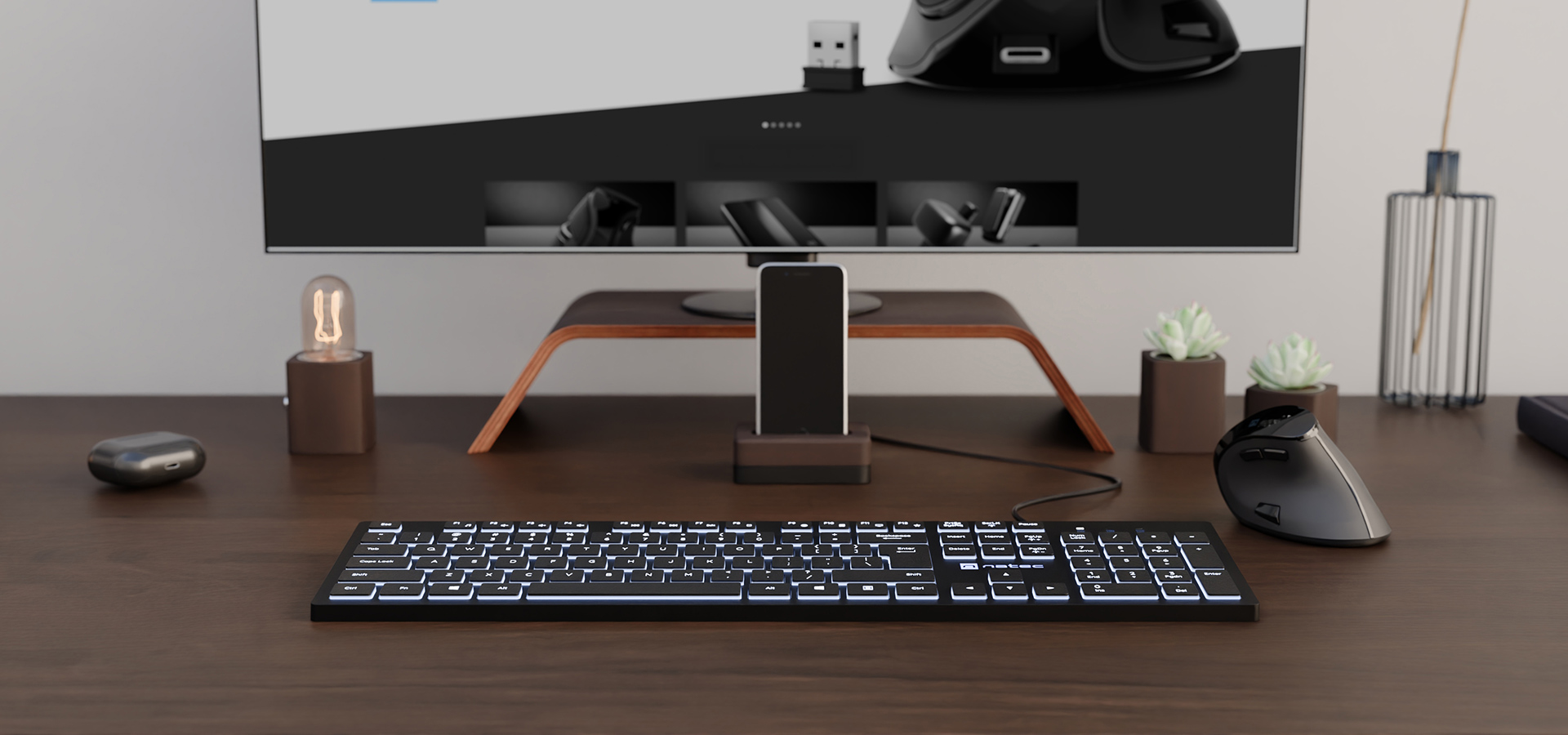 Czarna klawiatura z białym podświetleniem umieszczona na biurku z monitorem komputerowym i akcesoriami