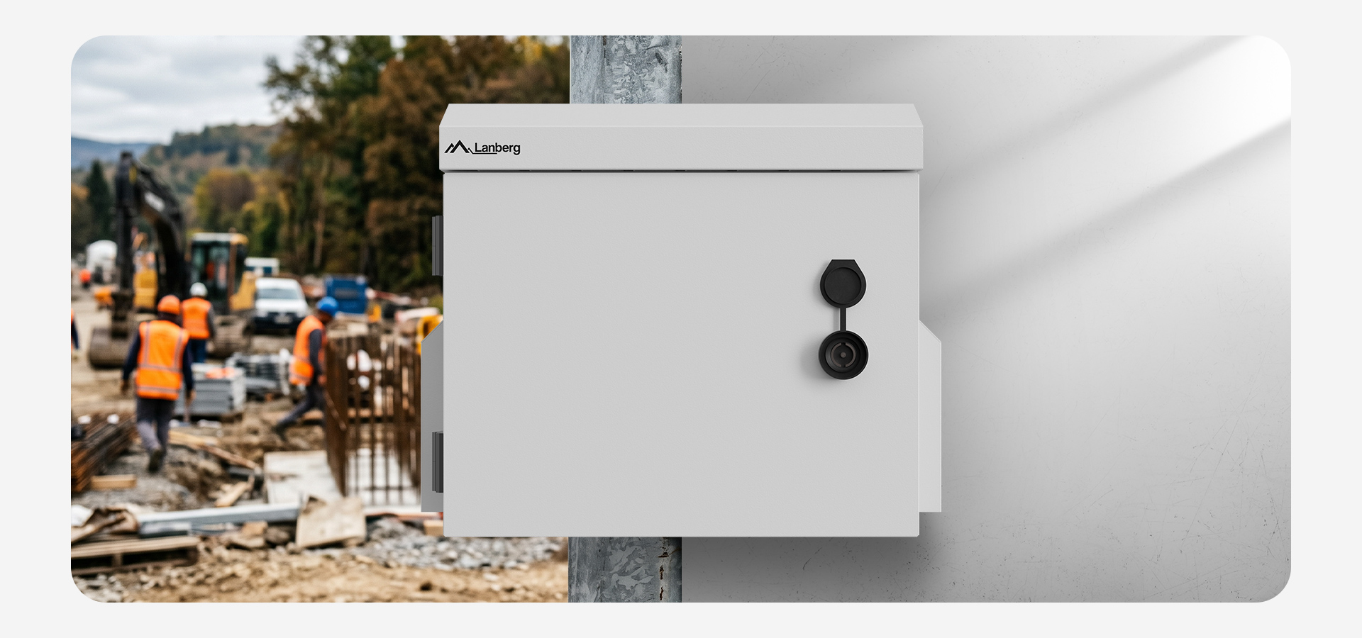 Secure white metal box attached to a wall with a lock, construction site in the background.